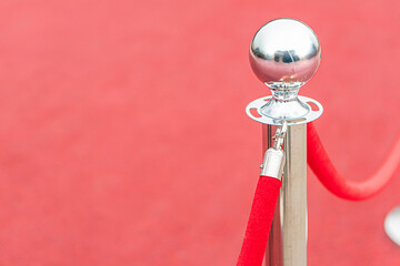 Red sphere on stand in red setting, reflective surface, diffuse artificial lighting, interior space...