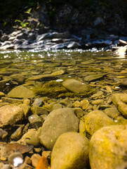 A stream running through a rocky river bed filled with rocks