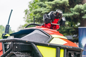Close-up view of a quad bike, red and white with yellow accents, possibly used for rescue...
