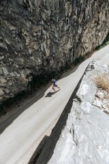 Aerial view of runner on mountain road.
