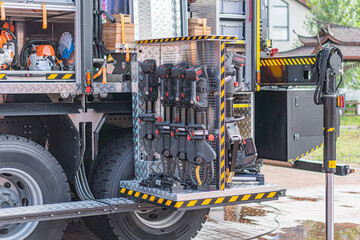 Close-up of a utilitarian, dark-colored truck with white compartments, labeled for water and...