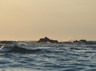 Sea and rocks into the sunset. Waterscape. Blue water background. Sea layout. Seawater background....