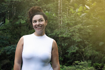 Happy woman in tropical forest, space text copy