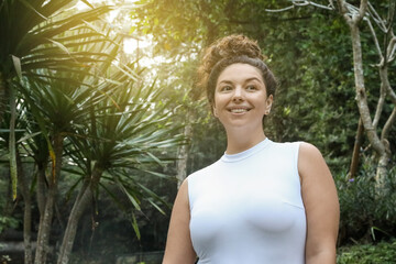 Happy woman in tropical forest, space text copy