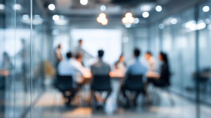 Blurred corporate meeting with colleagues brainstorming ideas inside glass conference room with modern lighting, a professional workspace.