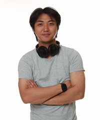 Portrait of handsome Asian man with headphones on white background