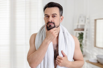Portrait of handsome man before shaving in bathroom