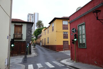 Charming European Street Intersection with Colorful Buildings and Vintage Traffic Lights on Tenerife. A scenic urban intersection featuring historic colorful buildings, green signal lights