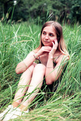 Young woman lying on grass outdoor in nature during summer for peace or quiet on a field. Spring, garden and relax outside on green ground in a countryside