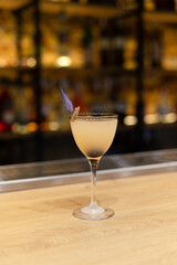 sour cocktail drink with ice cubes. Pisco sour alcohol cocktail on blur background surface.