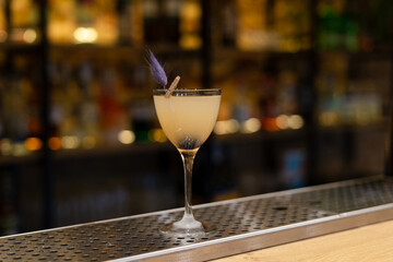 sour cocktail drink with ice cubes. Pisco sour alcohol cocktail on blur background surface.
