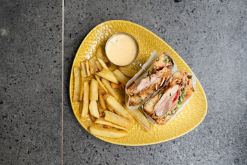 club sandwich for dinner with cheese and meat and fried potatoes