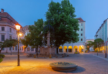 Quiet cobbled street in Nikolai Quarter at dawn in Berlin Germany with soft lighting and historic buildings