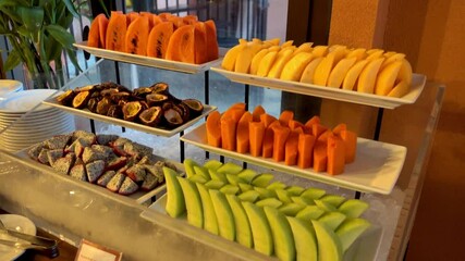 A colorful and fresh fruit buffet display at a restaurant