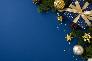 Beautiful holiday arrangement featuring a gift with golden ribbon, ornaments, and fir branches,...