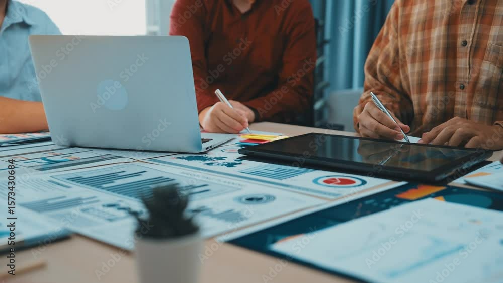 Poster professional teamwork environment with diverse individuals collaborating over laptops and tablets, a