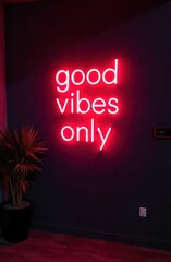 glowing neon sign displaying "good vibes only" against dark wall, accompanied by plant. modern motivational design. interior decor, positive messaging, lifestyle motto