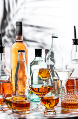 Strong alcoholic drinks displayed in various glasses and bottles showcasing a range of spirits