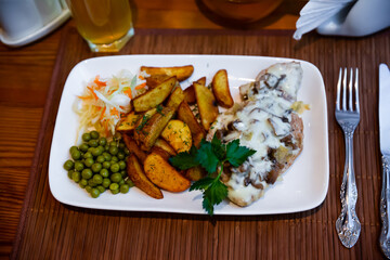Baked meat with mushrooms, potatoes and sauerkraut. Russian cuisine