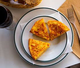 Appetizing tortilla with ham on a white plate
