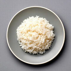 A small plate of white rice photographed from top view, pure gray background, perfect overhead composition, ultra-realistic texture, minimal editorial style, high-end food styling with soft natural