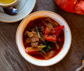 Traditional dish of Kazakhstan cuisine - thick spicy laghman with lamb meat, vegetables and noodles .