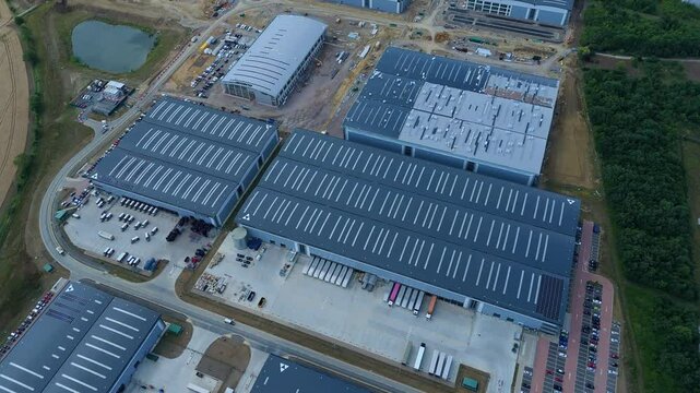 Aerial drone perspective distribution centers and industrial warehouses and data centers centres Quantum computing business hub super market distributor near Biggleswade England UK