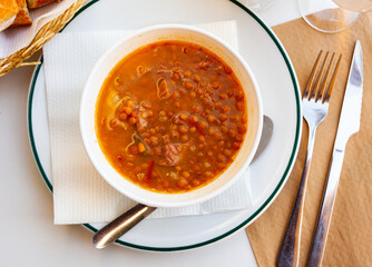 Stewed lentils with chorizo and vegetables with thick tomato sauce, dish of Spanish cuisine Riojan...