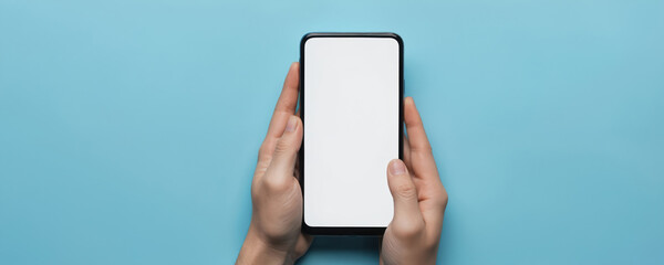 Person holding modern black smartphone with blank white screen against vibrant blue background. Device sleek, shiny, ready for custom content app interfaces. Ideal for tech, communication, digital