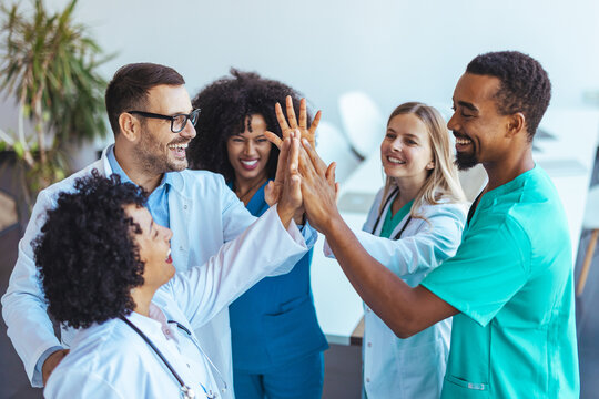 Group of Medical Professionals Celebrating Success With a Team High-Five