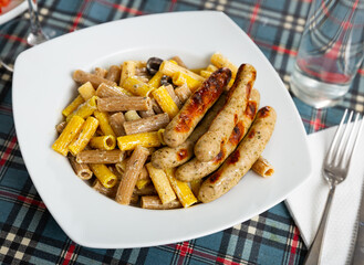 Appetizing Rigatoni pasta with hot sausages in a creamy sauce