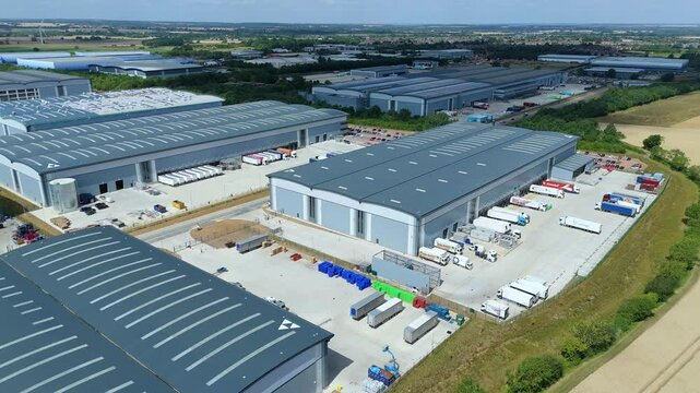 Aerial drone perspective distribution centers and industrial warehouses and data centers centres Quantum computing business hub super market distributor near Biggleswade England UK