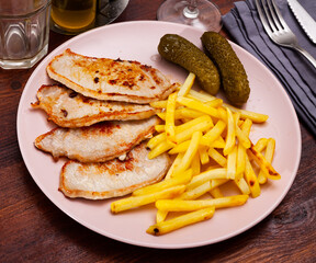 Close up of pork loin with potato and pickle, dish of russian cuisine