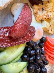 Turkish breakfast with spicy sausage and assorted salad elements