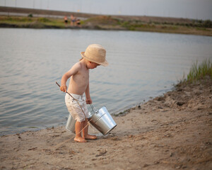 One preschool boy play fishermen near the water, showing innocence and togetherness, enjoying the...