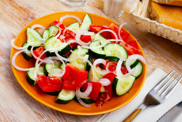 Appetizing summer cucumber and tomato salad closeup