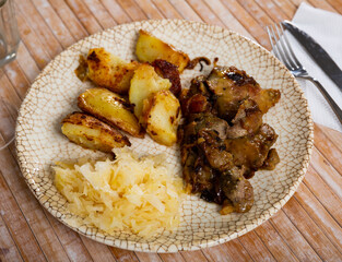 Delicious dish of fried rabbit liver with a side dish on a plate