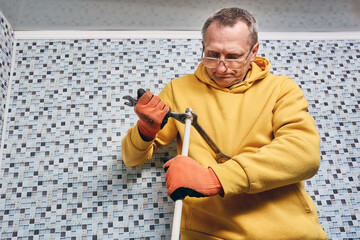 Installation of compression fitting on composite pipe is performed by plumber tightening securing...