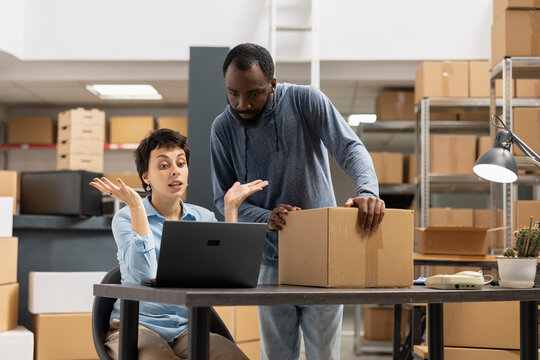 Staff members struggling with an order processing mix up in the supply room, managing distribution and getting angry due to import export trouble. Unhappy frustrated employees in depot.