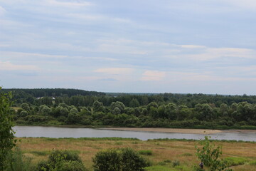 Scenic river view showcasing lush greenery and a serene landscape during a calm day in a rural area