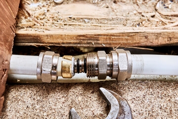 Compression coupling is positioned with insert facing inside multilayer pipe where compression ring...