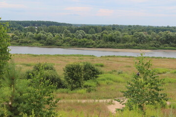 Scenic river landscape featuring dense greenery and serene waterway during a calm afternoon in a rural area