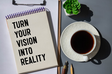 White notebook and text Turn your vision into reality
