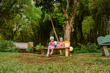 Outdoor birthday celebration with twin Colombian girls in a natural park surrounded by balloons, fantasy crowns and family joy