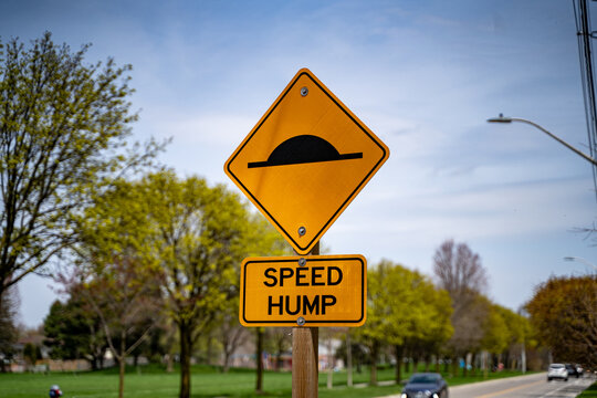 View of speed hump sign on the road.