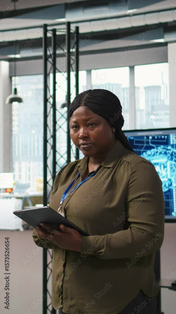 Poster vertical video happy female engineer in office automating repetitive tasks using ai scripts. jolly a