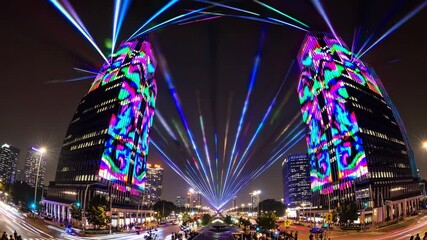 Colorful laser beams illuminating towering skyscrapers during a vibrant night light festival, creating a festive and energetic atmosphere throughout the bustling urban landscape - Powered by Adobe