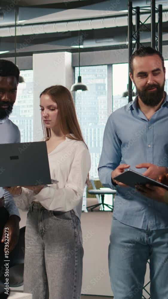Fototapete Vertical video Portrait of teamworking programmers in office developing apps using AI automation. Team of smiling IT experts working on devices, debugging applications with artificial intelligence