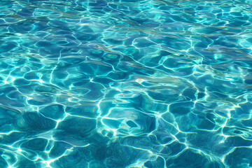 Obraz premium A close up view of shimmering turquoise water with light reflecting off of the surface of the water