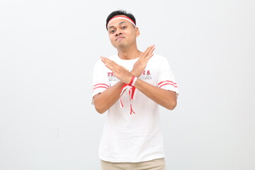Indonesian man with red and white ribbon, celebrating Indonesian independence day while standing...